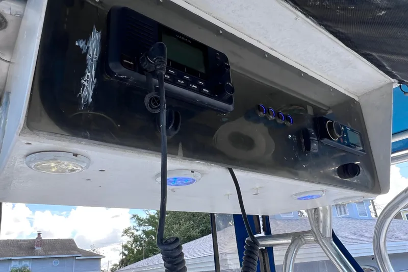 Slide: The Image of 2001 Cobia 254 Center Console dashboard with marine electronics and controls. - 30