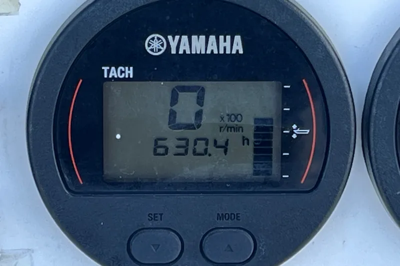 Slide: The Image of Yamaha tachometer displaying 630.4 hours on a 2001 Cobia 254 Center Console boat. - 27