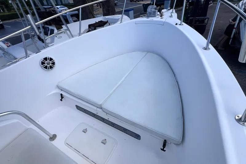 Slide: The Image of 2001 Cobia 254 Center Console boat interior with cushioned seating and stainless steel railings. - 36