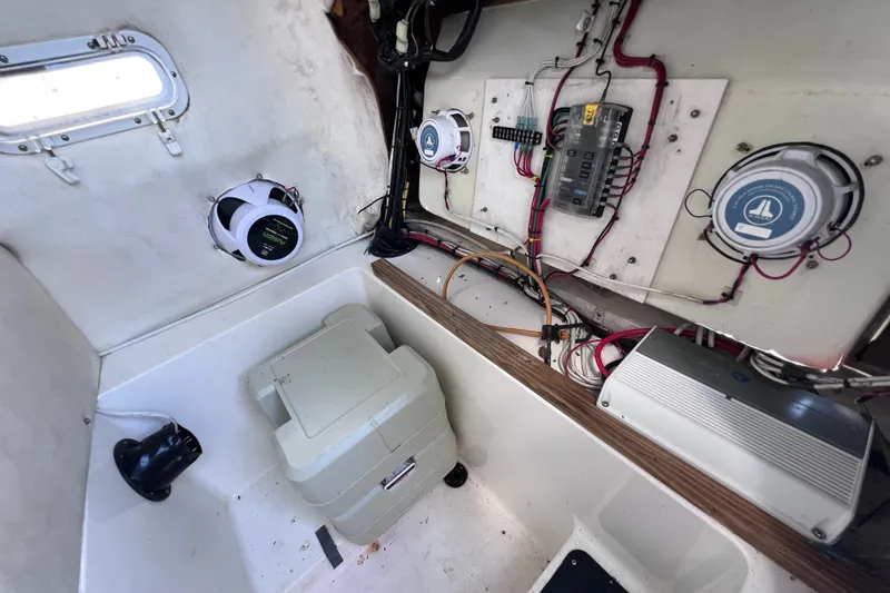 Slide: The Image of Interior view of a 2001 Cobia 254 Center Console boat showing wiring and speakers. - 42