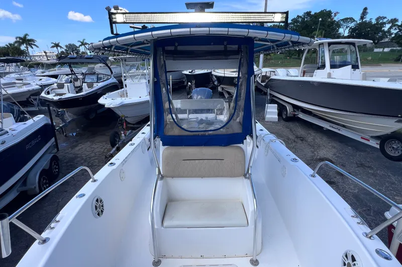 Slide: The Image of 2001 Cobia 254 Center Console boat at a marina with other vessels. - 38
