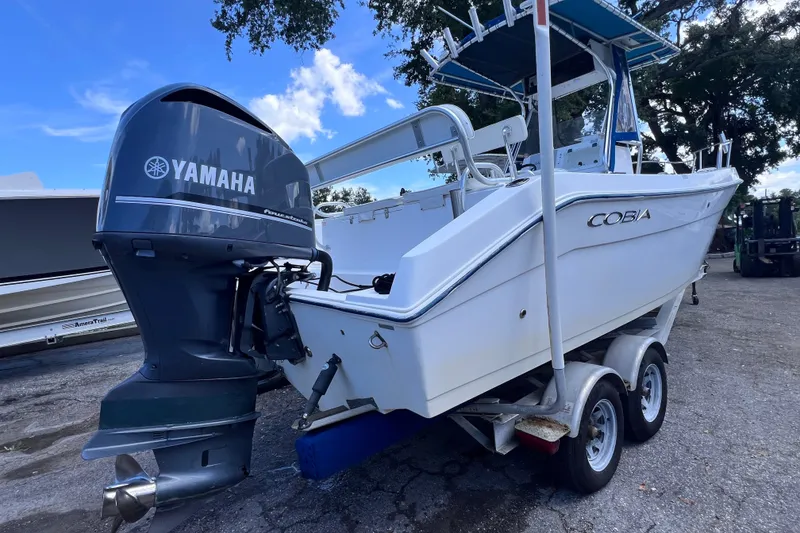 Slide: The Image of 2001 Cobia 254 Center Console boat with Yamaha outboard motor on trailer. - 1