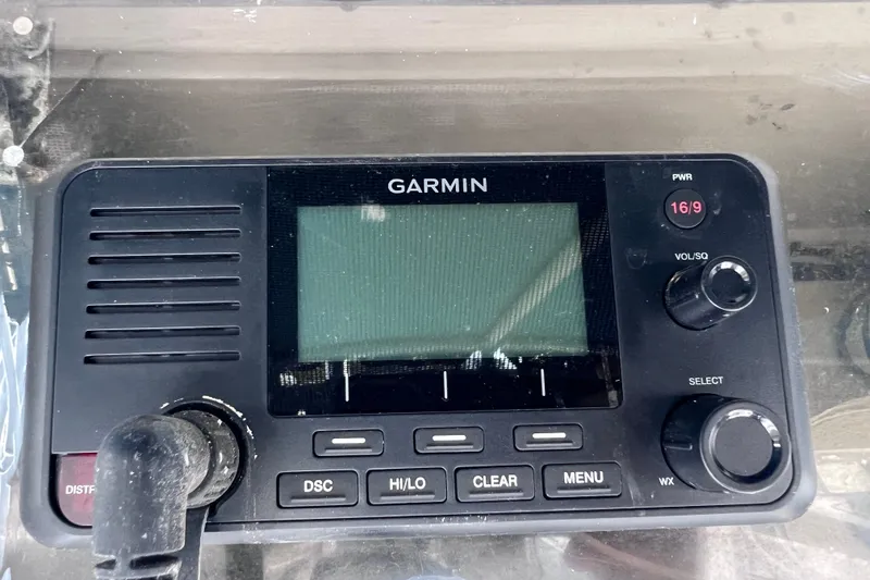 Slide: The Image of Garmin marine radio on 2001 Cobia 254 Center Console boat dashboard. - 33