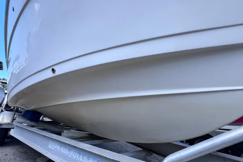 Slide: The Image of 2001 Cobia 254 Center Console boat on trailer, showcasing hull design. - 8