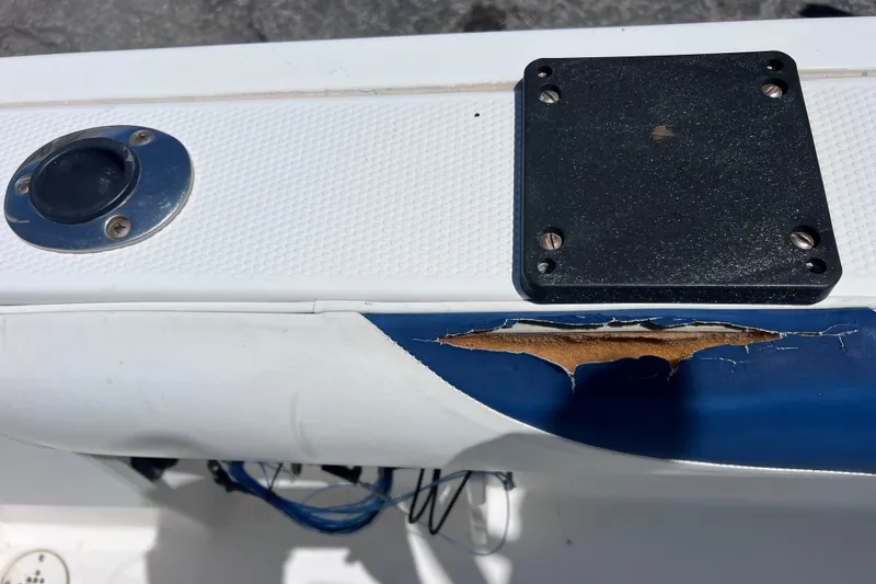 Slide: The Image of Damaged section on 2001 Cobia 254 Center Console boat with exposed interior. - 17