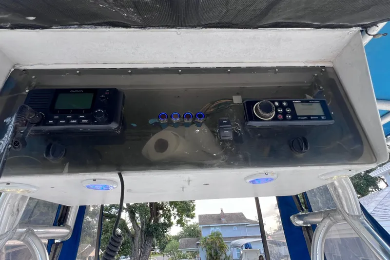 Slide: The Image of 2001 Cobia 254 Center Console dashboard with Garmin and Fusion marine electronics. - 34
