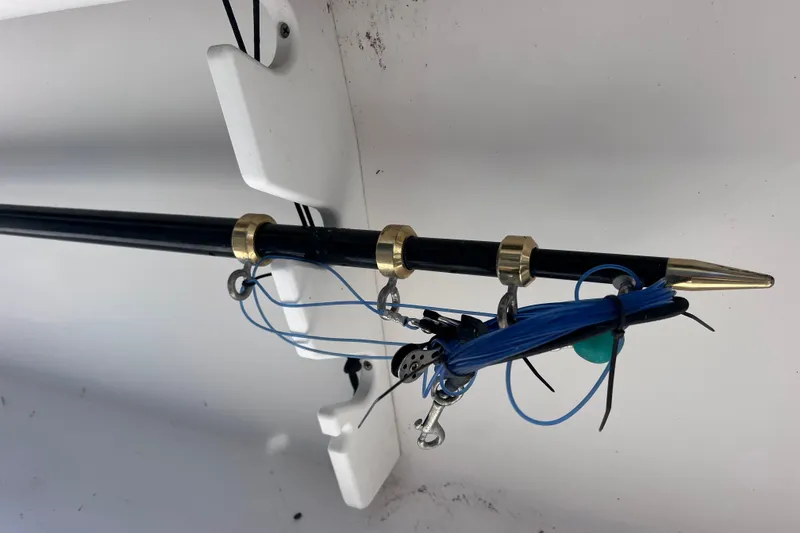 Slide: The Image of Fishing rod holder on 2001 Cobia 254 Center Console boat, featuring blue fishing line. - 13