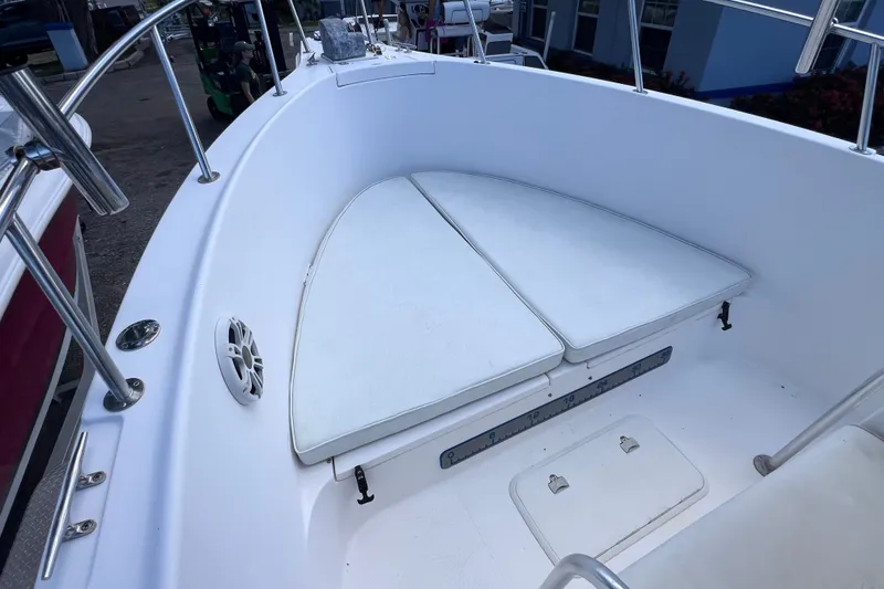 Slide: The Image of 2001 Cobia 254 Center Console boat interior with cushioned seating and stainless steel railings. - 35