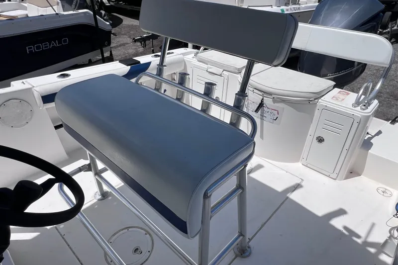 Slide: The Image of 2001 Cobia 254 Center Console boat interior with seating and storage compartments. - 19