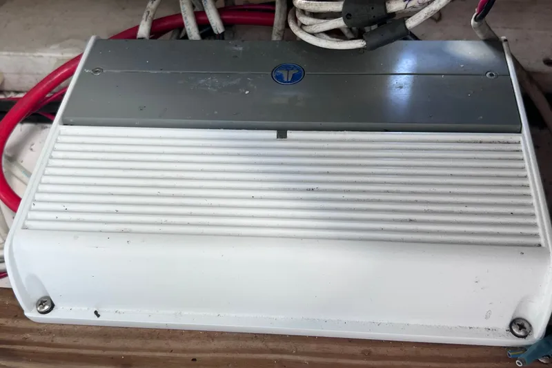 Slide: The Image of Electrical component in a 2001 Cobia 254 Center Console boat, featuring red and white cables. - 43