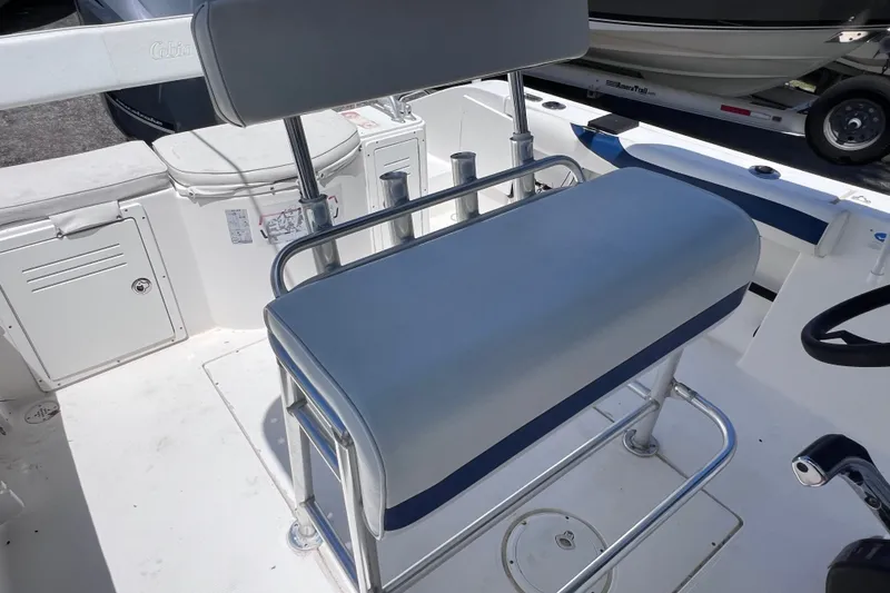 Slide: The Image of 2001 Cobia 254 Center Console boat interior with seating and storage compartments. - 18