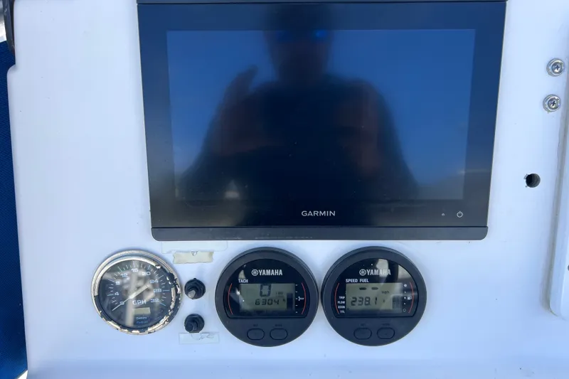 Slide: The Image of Dashboard of 2001 Cobia 254 Center Console with Garmin display and Yamaha gauges. - 21