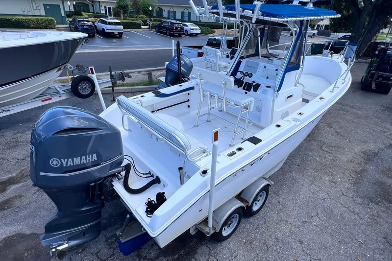 The Image of 2001 Cobia 254 Center Console boat with Yamaha outboard motor on trailer. - 0
