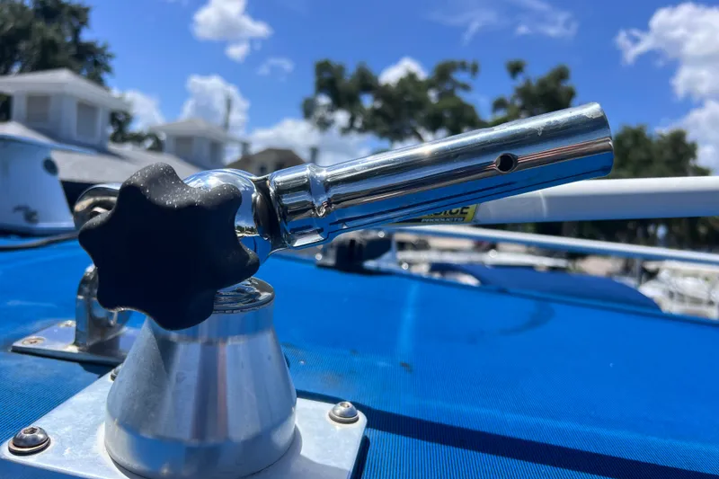 Slide: The Image of Close-up of a 2001 Cobia 254 Center Console boat detail under a clear blue sky. - 16