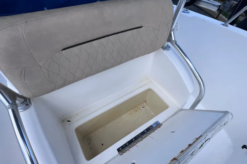 Slide: The Image of Cobia 254 Center Console 2001 boat seat with storage compartment open. - 39