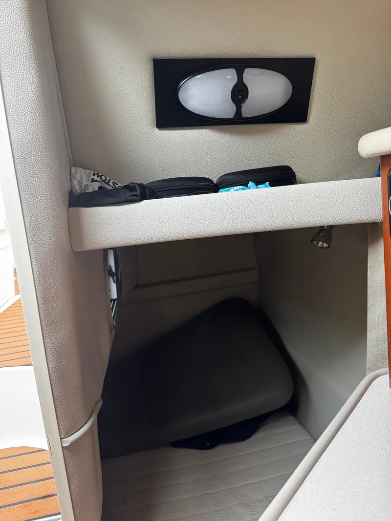 Slide: The Image of Interior of a 2004 Chaparral Signature 240 with a small sleeping area and storage space. - 11