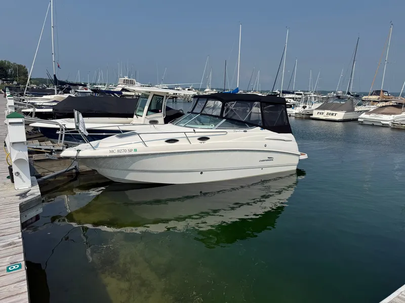 The Image of 2004 Chaparral Signature 240 docked in a marina, surrounded by other boats. - 0