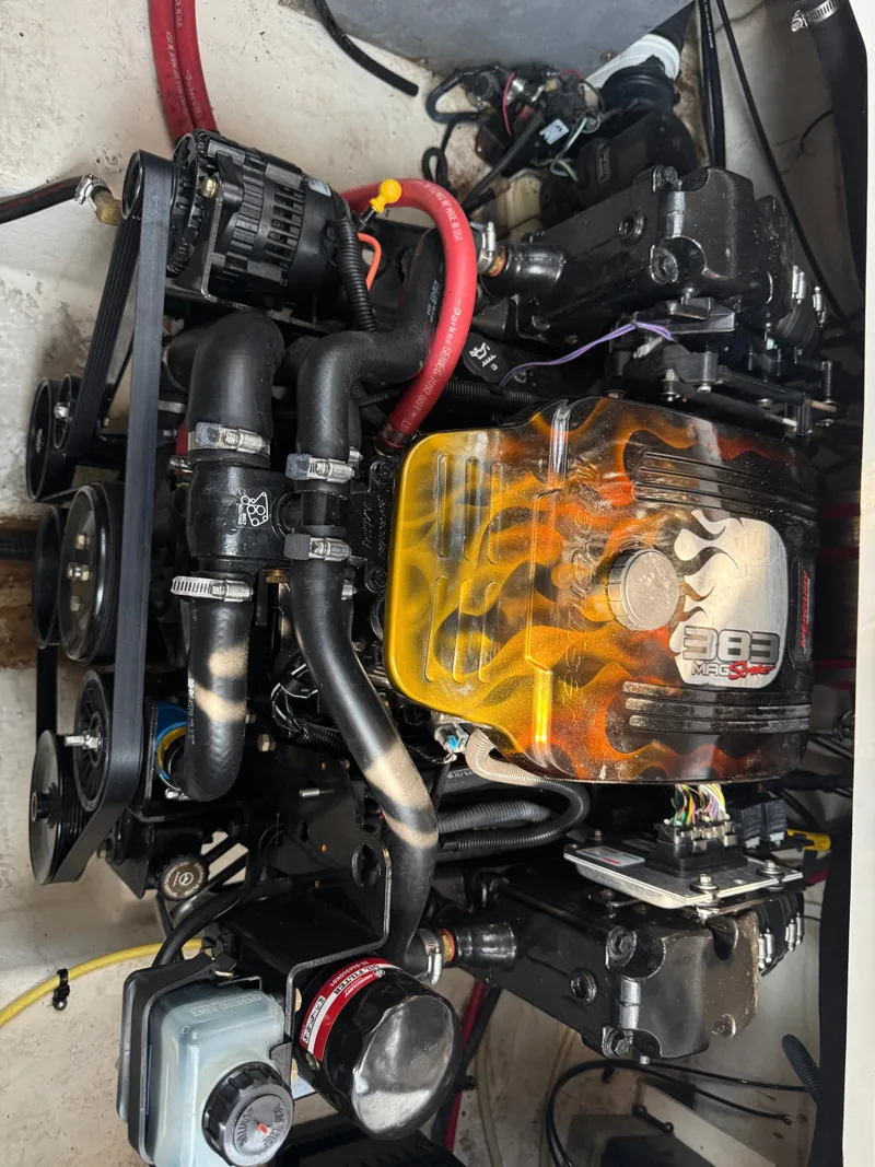 Slide: The Image of A powerful engine with a yellow cover and flame design in a boat's engine compartment. - 17