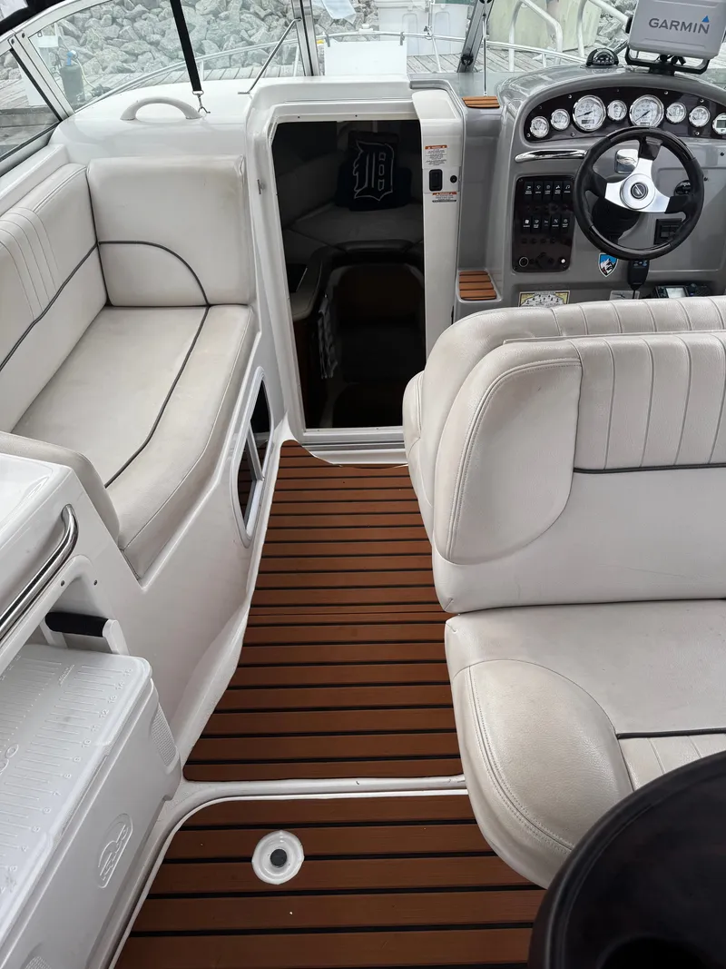 Slide: The Image of The image shows the cockpit of a 2004 Chaparral Signature 240 with white seating and wood flooring. - 4