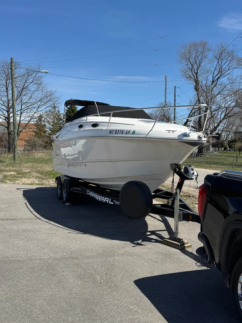 Slide: The Image of A white 2004 Chaparral Signature 240 boat on a trailer, ready for transport. - 21