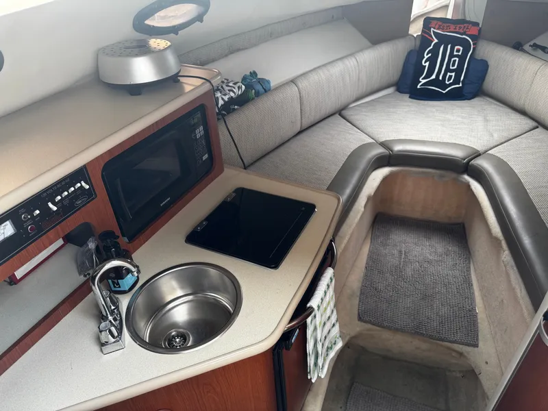 Slide: The Image of Interior of a 2004 Chaparral Signature 240 with kitchenette and seating area. - 12