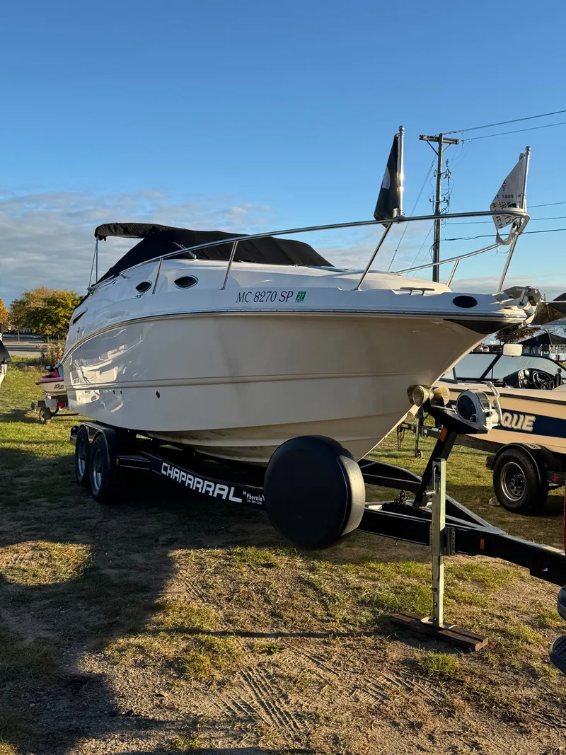 Slide: The Image of A 2004 Chaparral Signature 240 boat is on a trailer outdoors. - 19