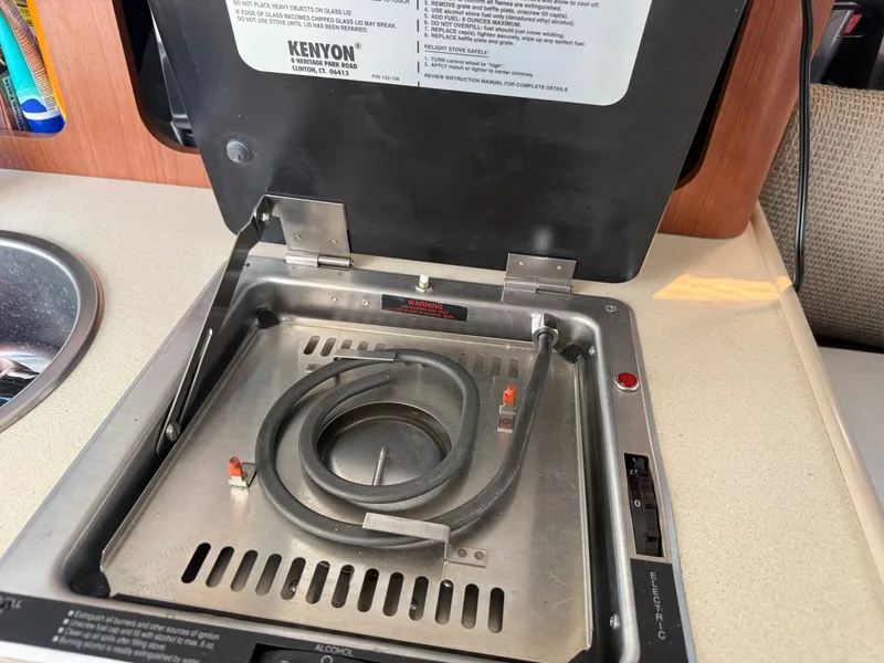 Slide: The Image of An electric stove with a heating coil in a boat's galley. - 15