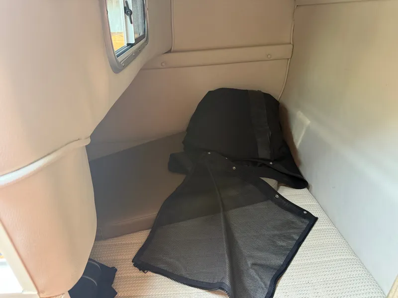 Slide: The Image of Interior of a 2004 Chaparral Signature 240 with padded seating and a window. - 10