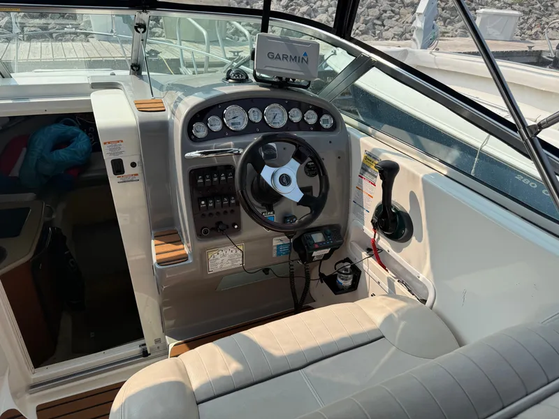 Slide: The Image of The cockpit of a 2004 Chaparral Signature 240 with a Garmin navigation system and sleek steering wheel. - 8