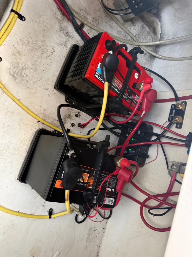Slide: The Image of Two boat batteries are installed in a compartment with cables and connectors. - 18