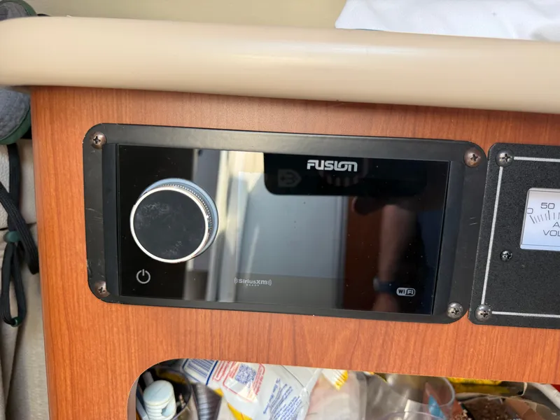 Slide: The Image of A Fusion audio system is embedded in a wooden dashboard, surrounded by various items. - 14