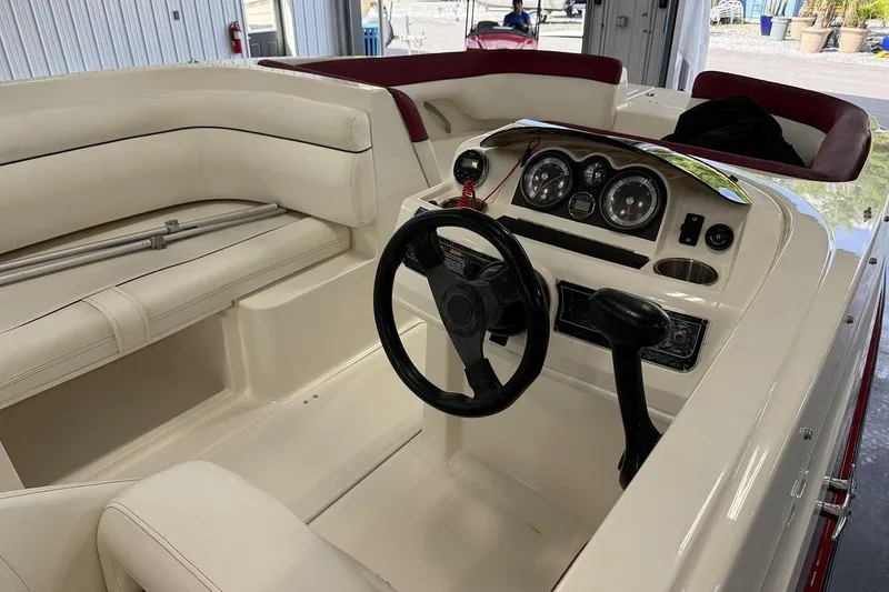 Slide: The Image of 2014 Bayliner 190 Deck Boat interior with steering wheel and dashboard controls. - 5