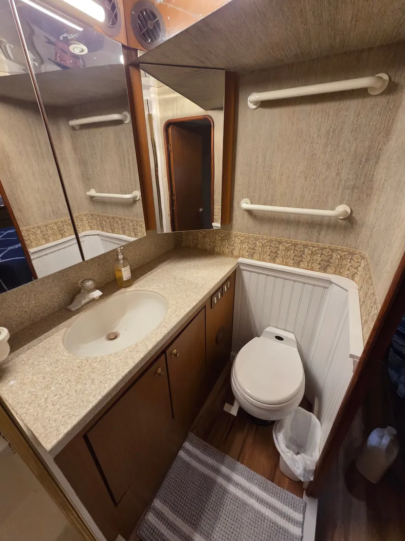 Slide: The Image of The image shows a boat bathroom with a sink, mirror, and toilet. - 11