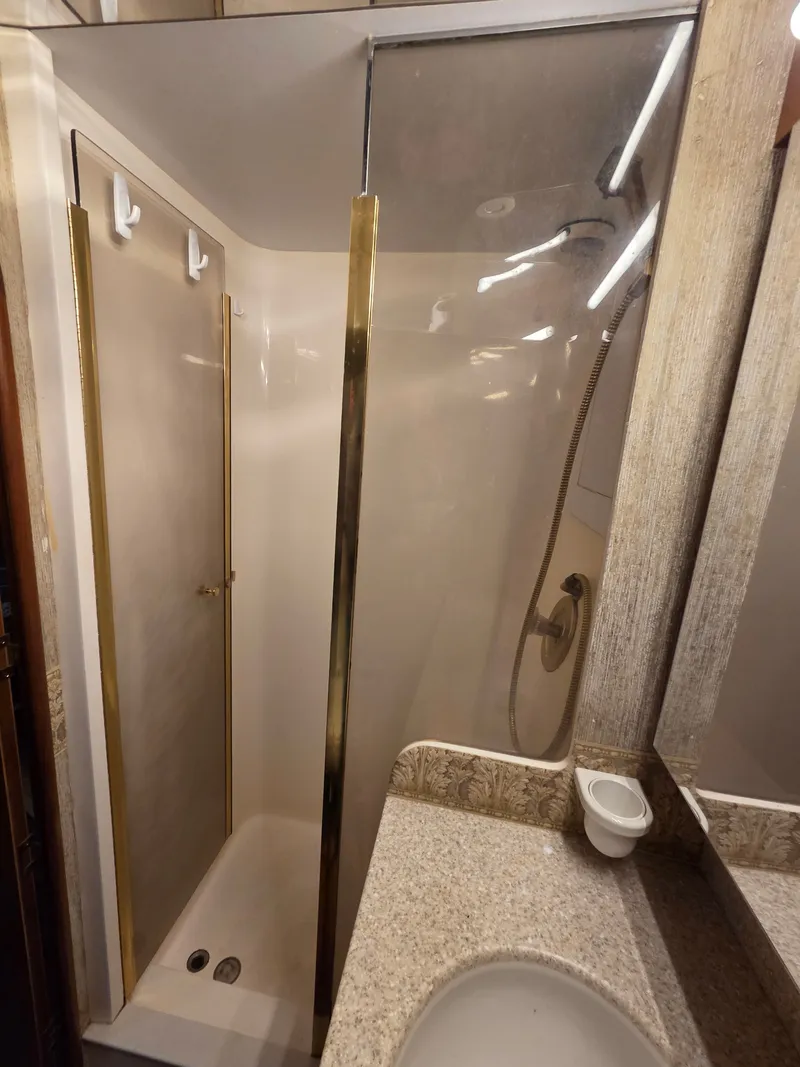 Slide: The Image of Bathroom in a 2002 Ocean Convertible yacht with a shower and sink. - 10