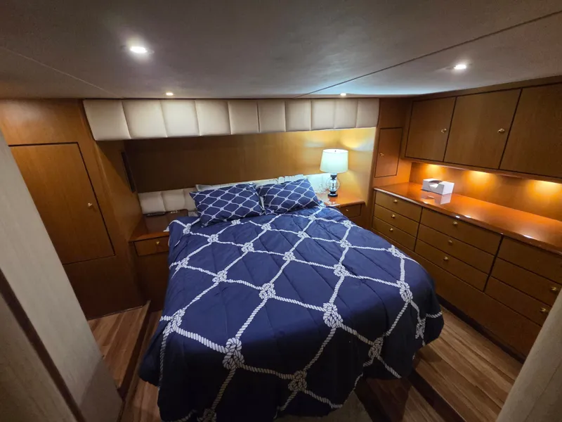 Slide: The Image of The image shows a cozy cabin with a double bed, wooden furniture, and soft lighting. - 7