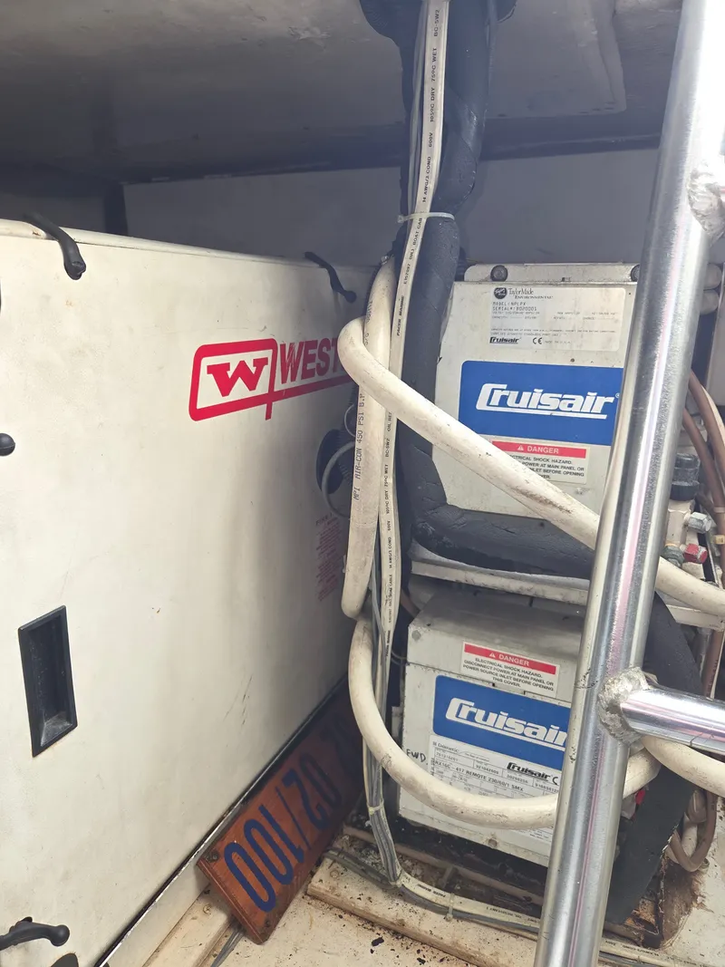 Slide: The Image of An engine room with Cruisair air conditioning units and West Marine equipment. - 36