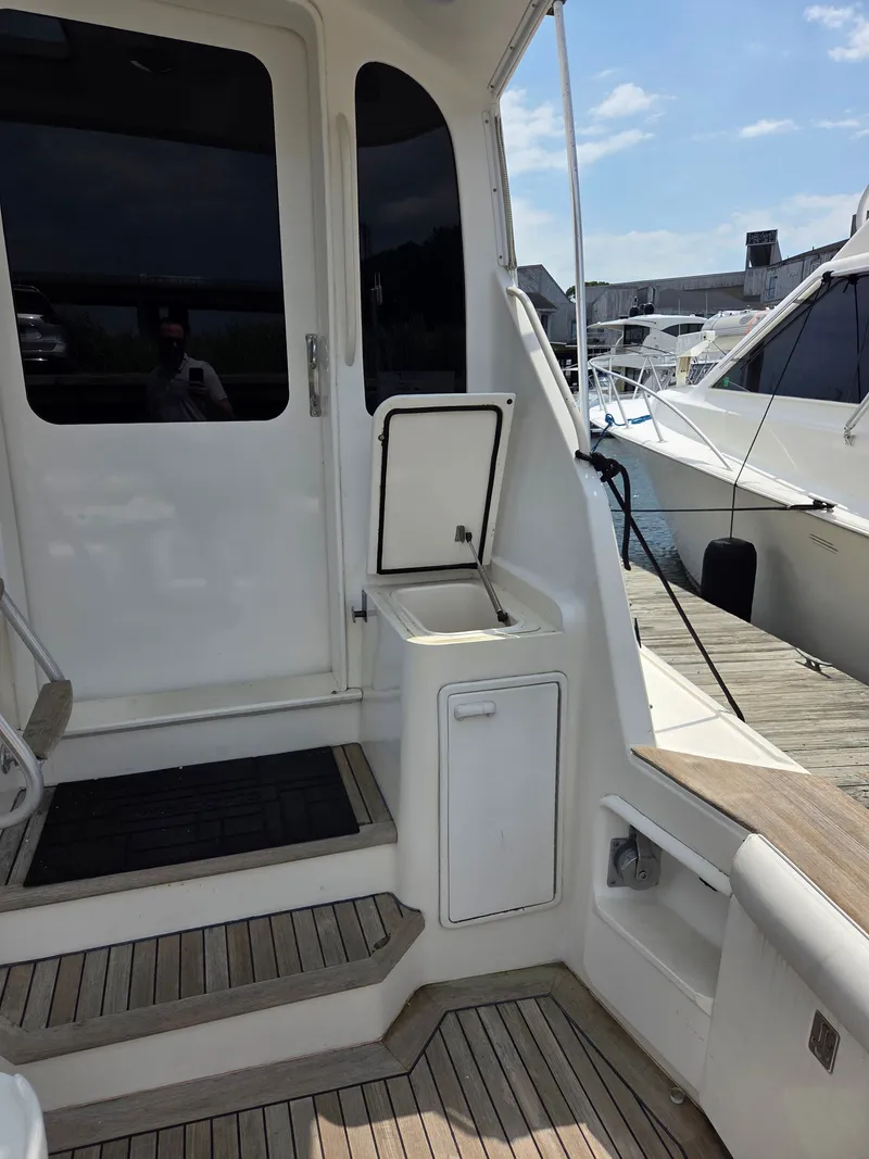 Slide: The Image of The 2002 Ocean Convertible features a well-maintained exterior staircase with wooden flooring and access door. - 39