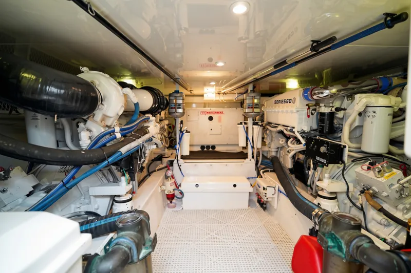 Slide: The Image of Engine room of a 2005 Post 50 Convertible yacht, showcasing mechanical components and systems. - 28