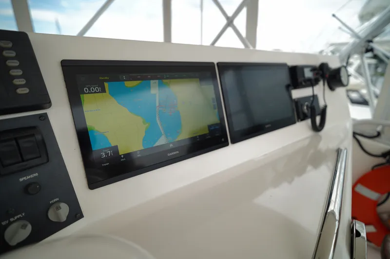 Slide: The Image of Control panel of a 2005 Post 50 Convertible boat with navigation screens. - 11