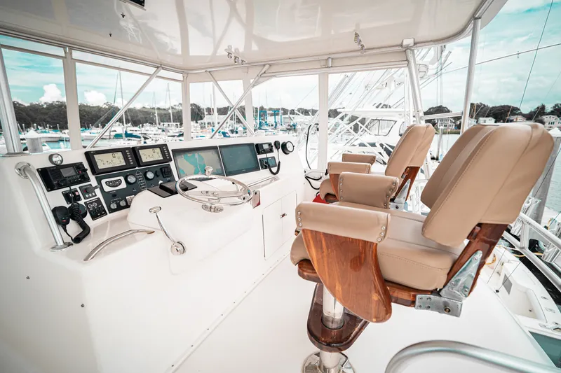 Slide: The Image of Luxurious helm of a 2005 Post 50 Convertible yacht with leather seats and advanced navigation equipment. - 8