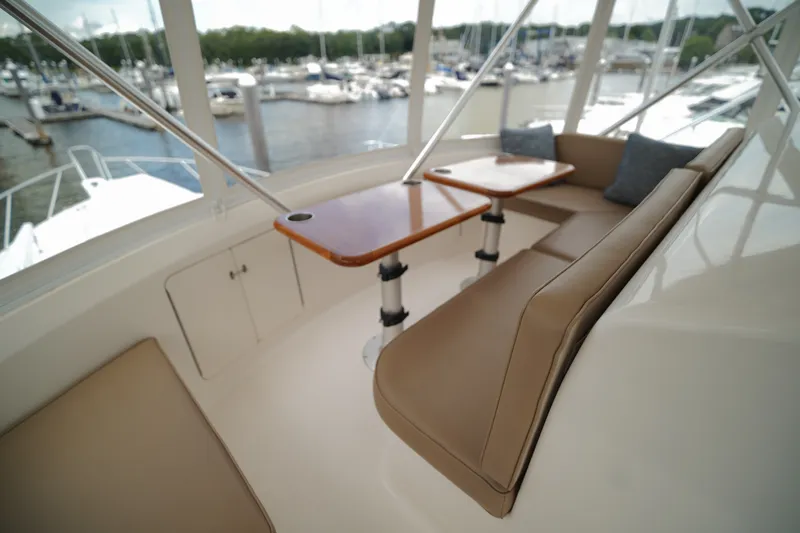 Slide: The Image of Luxurious seating area on a 2005 Post 50 Convertible yacht, docked at a marina. - 13