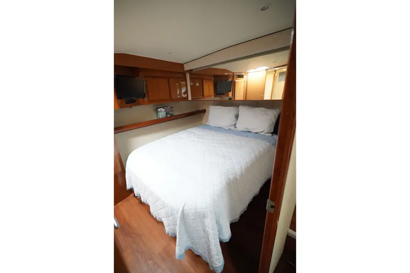 Slide: The Image of Luxurious cabin interior of a 2005 Post 50 Convertible yacht with cozy bedding. - 19