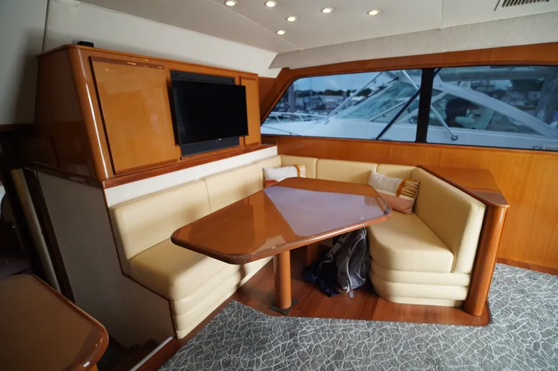 Slide: The Image of Luxurious interior of a 2005 Post 50 Convertible yacht with plush seating and a mounted TV. - 17
