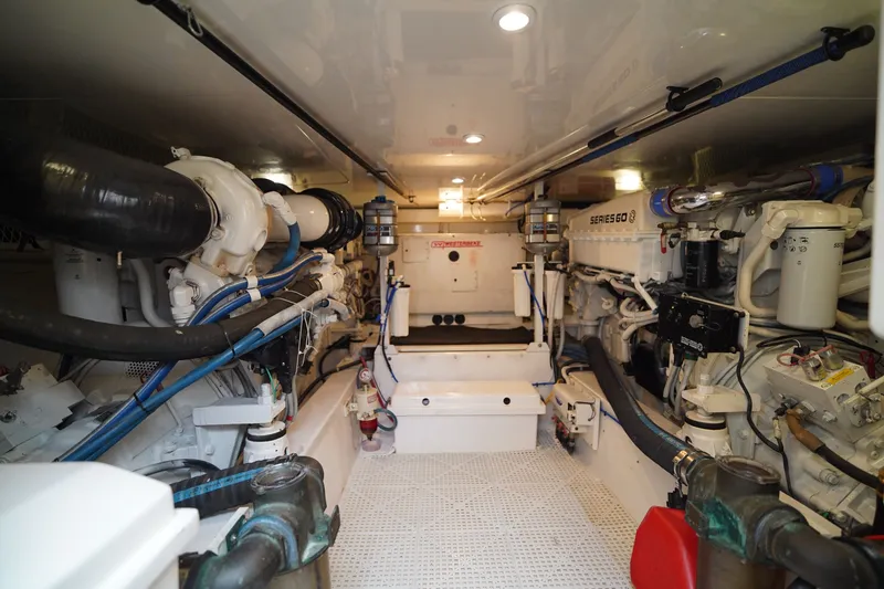 Slide: The Image of Engine room of a 2005 Post 50 Convertible yacht, showcasing mechanical components and systems. - 27