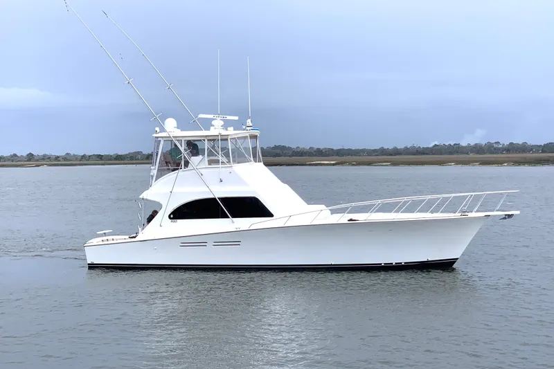 Slide: The Image of 2005 Post 50 Convertible yacht cruising on calm waters under a cloudy sky. - 4