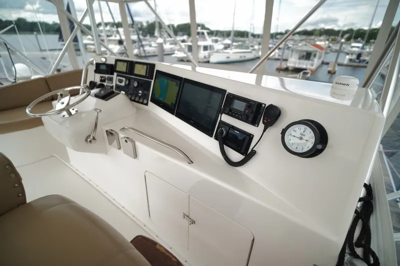Slide: The Image of Control panel of a 2005 Post 50 Convertible yacht with navigation instruments and steering wheel. - 10