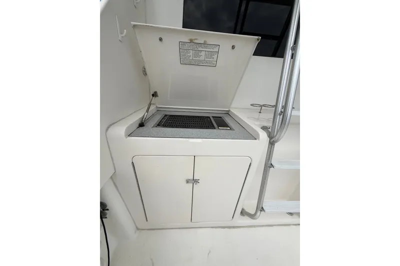 Slide: The Image of Outdoor grill station on a 2005 Post 50 Convertible yacht, featuring a sleek design. - 29