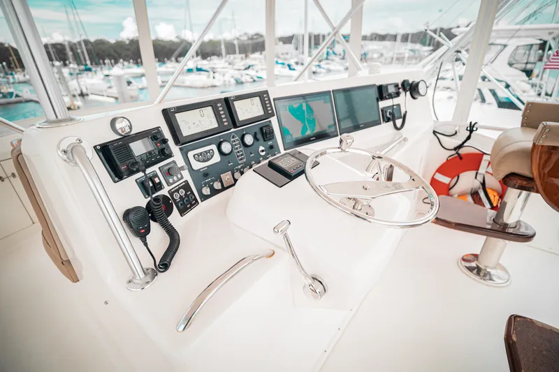 Slide: The Image of Control panel of a 2005 Post 50 Convertible yacht, featuring navigation and communication equipment. - 9