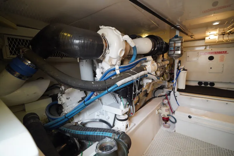 Slide: The Image of Engine room of a 2005 Post 50 Convertible yacht, showcasing mechanical components. - 26