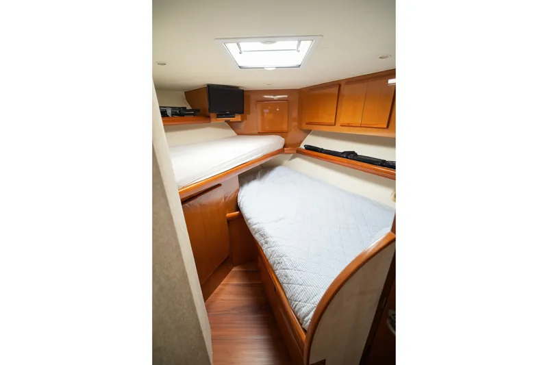 Slide: The Image of Interior of 2005 Post 50 Convertible yacht with cozy wooden cabin and bedding. - 22